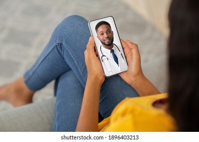 Telemedicine Concept. Unrecognizable Black Lady Using Smartphone, Making Video Conference With Her Therapist Doctor While Sitting On Couch At Home. Male Physician Consulting Patient Online, Collage