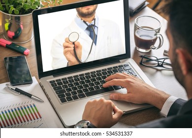 Telemedicine. Doctor On A Computer Screen In An Office Environment