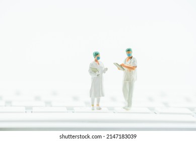 Telemedicine, Telehealth Or E-Health, Healthcare Concept : Physician Or A Doctor Holds A Patient History Form, A Nurse Reviews Data On A Computer Keyboard To Provide Advice And Long-distance Service.