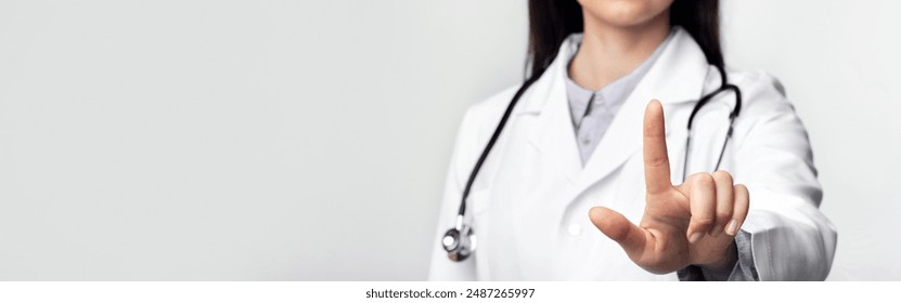 Telemedicine. Unrecognizable Doctor Using Invisible Medical Touchscreen Pressing Button In Studio Over White Background. Cropped, Panorama - Powered by Shutterstock