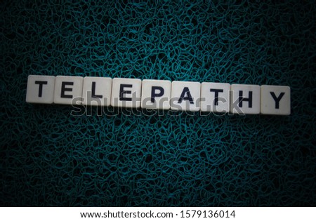 Telepathy, word cube with background.