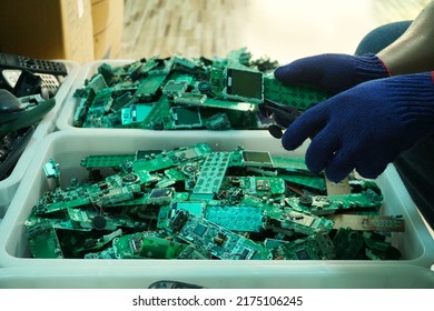 Telephone circuit board parts are being disassembled as electronic waste in the factory. - Shutterstock ID 2175106245