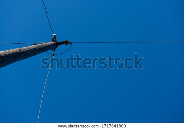 Telephone pole\
with lot of wires cutting the\
sky
