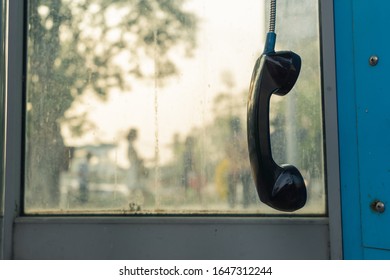 Telephone Receiver Hanging In Phone Booth