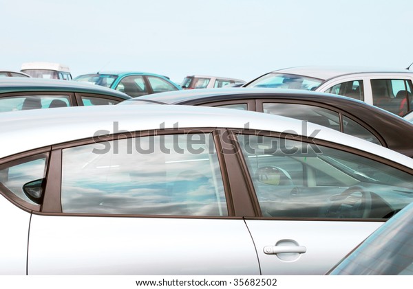 Telephoto view of\
cars parked in crowded car\
park