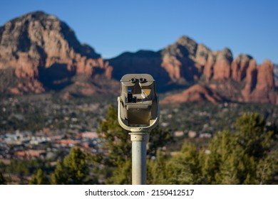 Telescope in front of iconic red rock beside Sedona Airport Scenic Lookout in Sedona Arizona