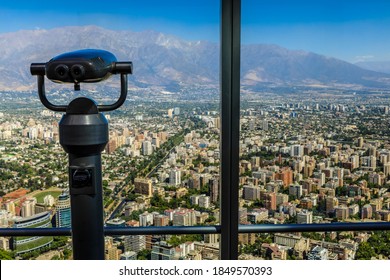 Telescope at the glass windows of the observatory of the Sky Costanera, with no people and Andes mountains view, Gran Torre Santiago, South America’s tallest building, Santiago, Chile 12.21.17