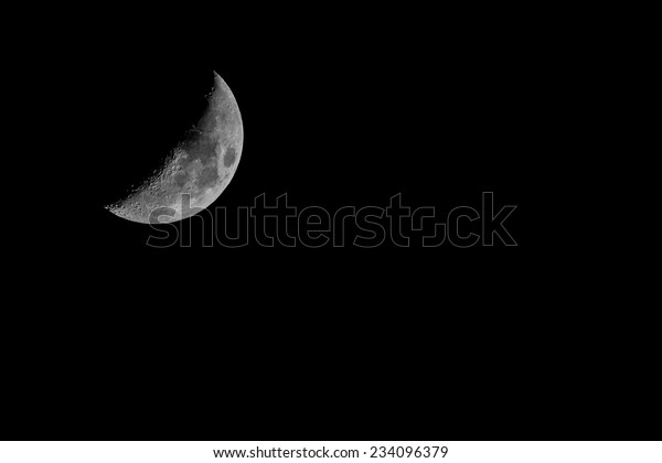telescopic view of a quarter\
of moon 