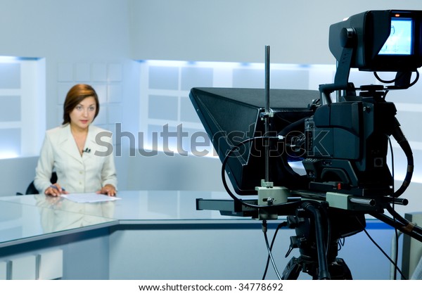 television\
anchorwoman at studio during live\
broadcasting