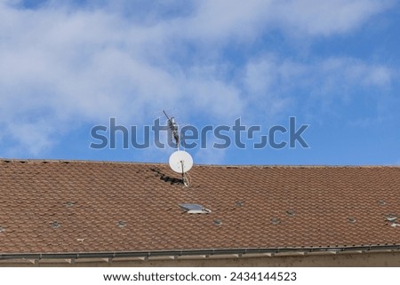 Television antenna and parabolic mirrors on a roof
