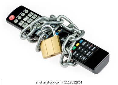 The Television Black Remote Control Is Closed By The Brass Padlock With A Metal Chain Isolated On White Background. Concept Of Unavailable Video Content Or Lack Of Spare Time For Watching