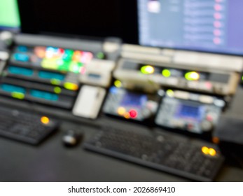 Television Broadcast Control Room Monitors In The Master Control Centre Of A TV Network. Blurry Out Of Focus Lights And Screens For A Background. TV News Production Background.   