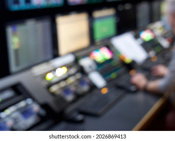 Television Broadcast Control Room Monitors In The Master Control Centre Of A TV Network. Blurry Out Of Focus Lights And Screens For A Background. TV News Production Background.   