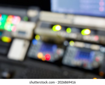 Television Broadcast Control Room Monitors In The Master Control Centre Of A TV Network. Blurry Out Of Focus Lights And Screens For A Background. TV News Production Background.   