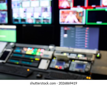 Television Broadcast Control Room Monitors In The Master Control Centre Of A TV Network. Blurry Out Of Focus Lights And Screens For A Background. TV News Production Background.   