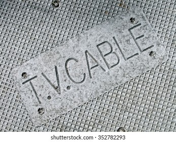 television cable as text on silver metal manhole, modern telecommunication details - Powered by Shutterstock