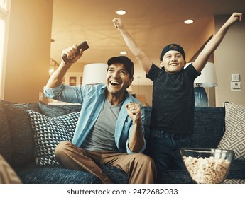 Television, child and man with success on sofa for streaming, subscription or watching sports together. Kid, dad and popcorn with tv remote at home for bonding, celebration or live broadcast of match - Powered by Shutterstock