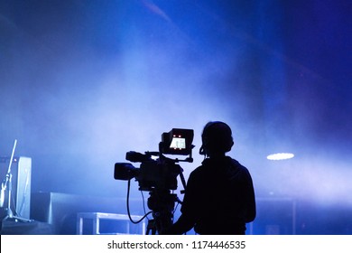 Television Live Streaming Cameraman During A Concert. Live Action. Blues Tone