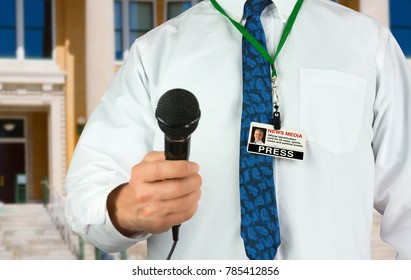 Television Reporter With Microphone And Press Pass News Media Card In A Bright White Shirt And Colorful Blue Tie Closeup As He Stands In Front Of A Stairs Outside A Building.