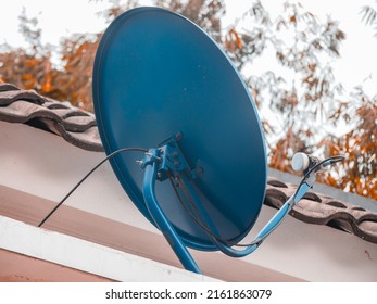 Television satellite dish installed above the house, which is common in rural areas