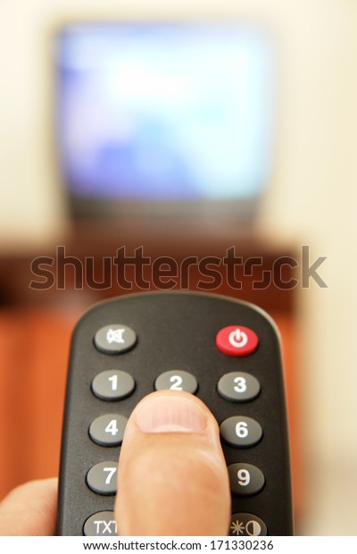 Television screen with tv remote control \
in foreground.....