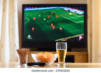 Television, TV Watching (football, Soccer Match) With Snacks Lying On Table - Stock Photo