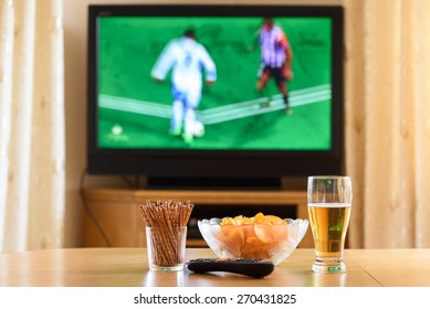 Television, TV Watching (football, Soccer Match) With Snacks Lying On Table - Stock Photo