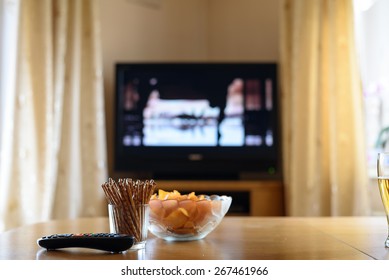 Television, TV Watching (movie) With Snacks Lying On Table - Stock Photo