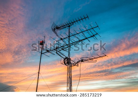 televisions antennas with sunset cloudy sky background