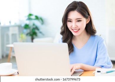 Telework Concept - Asian Woman Use Computer To Work And Has A Video Meeting At Home