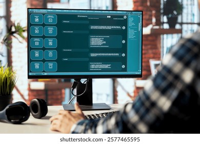 Teleworking man using artificial intelligence GPT trained on textual data to understand and produce natural sounding human language. Close up of LLM powered chatbot on PC display