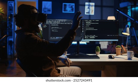 Teleworking programmer using futuristic VR glasses in home office to do javascript programming. IT expert wearing high tech virtual reality headset to visualize lines of code, camera B - Powered by Shutterstock