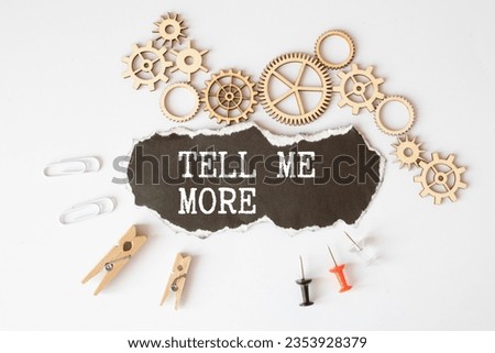 Tell me more symbol. Concept words Tell me more on wooden notebook. Beautiful wooden background. Business and Tell me more concept. Copy space.