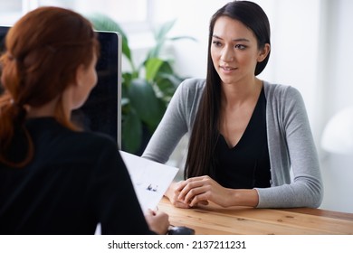 Tell me something about yourself thats not in your resume. Shot of two young professionals having a discussion at a desk.