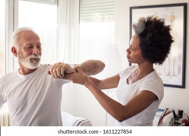 Tell Me If You Experience Discomfort. Physiotherapist Working With Patient.