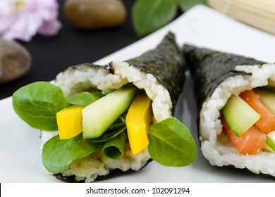 Temaki - Japanese hand rolled sushi. One with pea shoot, cucumber and peppers another with salmon, cucumber, chives and soft cheese.