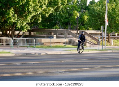 TEMPE, AZ/USA - JULY 2nd, 2020: Bicycle Cop Arrives On Scene At Tempe City Hall, Takes A Quick Look And Then Proceeds To Turn Around Just As Fast.