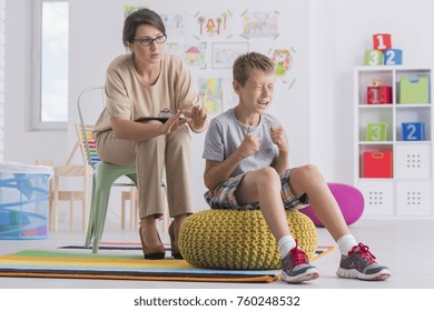 Temper Tantrum Concept, Little Angry Emotional Boy Being Aggressive During Therapy Session With Child Psychotherapist