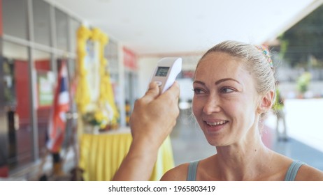 Temperature Check At A Supermarket Of Woman, Grocery Store With Thermal Imaging Camera Installed. Coronavirus Covid-19.