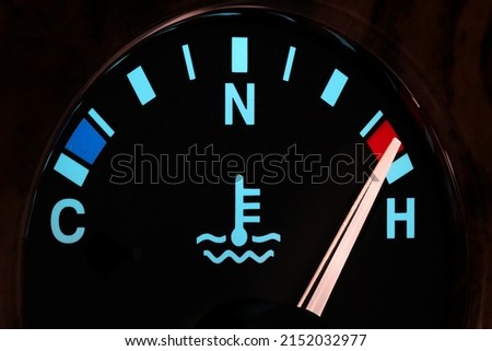 temperature gauge in car dashboard in illuminated night mode - hot