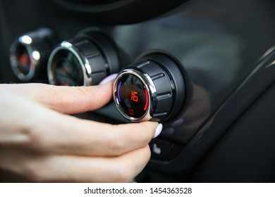 the temperature inside car is 16 degrees. setting the temperature climate control in the car - Shutterstock ID 1454363528