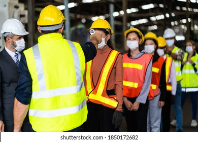 Temperature measurement with employee temperature meter before entering work at factory. Professional engineering team. - Shutterstock ID 1850172682