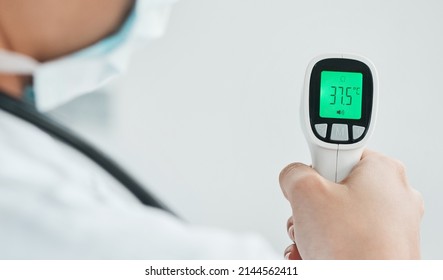 Temperature Screening Will Take Place For Anyone Entering Our Hospital. Cropped Shot Of A Medical Practitioner Holding A Infrared Thermometer.