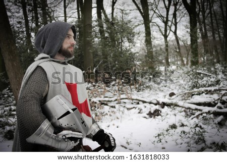 Templar walking with helm off,  crusade knight in wintery forest for a educational reenactment project