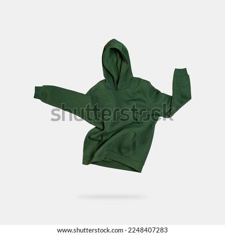 Template blank isolated hoodie. Green men's hoodie, sweatshirt with hood flies on light gray background. Mockup isolate Men's clothing for logo, design, advertising, print. Creative clothing concept 