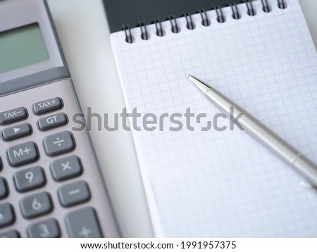 Template with caculator pen notepad on white table top view background.