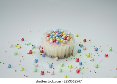 Template with a cheesecake and colorful sprinkles on a white background. Copy space. Selective focus. Birthday or Valentine's Day dessert backdrop. Space for text. - Shutterstock ID 2253562547