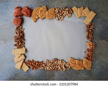 Template or frame designed with punjabi local dishes and food for winter season or lohri festival. Frame decorated with marunda, groundnut, almonds, walnuts and jaggery. 