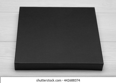 Template Photo. Black Flat Box On White Table. Mockup Ready For Your Desigh