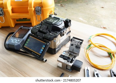 template Technician Fiberoptic Fusion Splicing. Worker connecting for Cable Internet signal and Wire connection with Fiber Optic Fusion Splicing machine,fiber optic cable splice machine in work